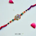 Regal Blossom Rakhi – RK-186 | Elegant Floral Rakhi with Stone Studded Center & Multicolor Beads for Brother