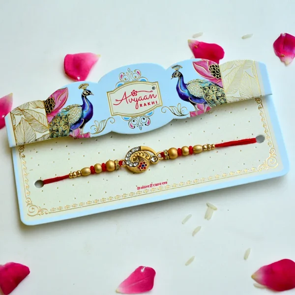 Ethnic Golden Crescent Rakhi – RK-202 | Intricate Motif, Studded Stones & Red-Gold Beads - Image 2