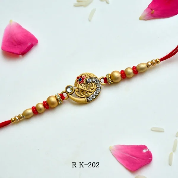 Ethnic Golden Crescent Rakhi – RK-202 | Intricate Motif, Studded Stones & Red-Gold Beads - Image 1