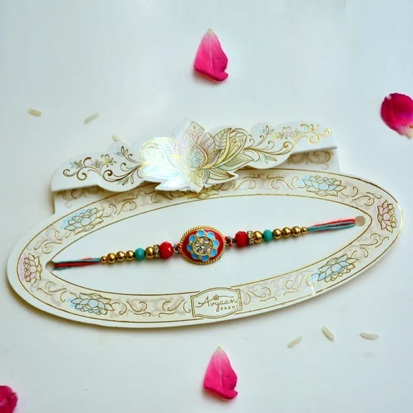 Vibrant Oval Meenakari Rakhi – RK-205 | Red & Blue Enamel Rakhi with Crystal Studded Centerpiece - Image 2