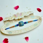 Cerulean Blossom Rakhi – RK-210 | Elegant Floral Blue Rakhi with Beads & Crystals - Image 2