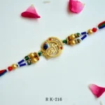 Divine Shree Symbol Rakhi – RK-216 | Elegant Spiritual Rakhi with Beads & Enamel Work