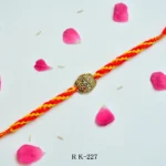 Royal Turban Rakhi – RK-227 | Traditional Brass Motif on Braided Yellow-Red Thread