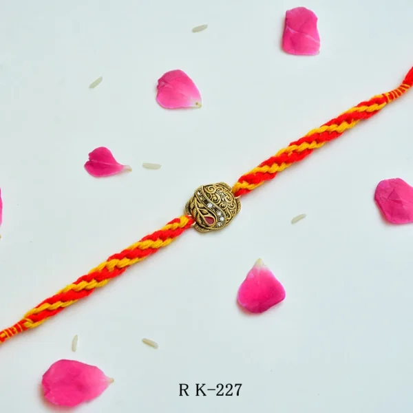 Royal Turban Rakhi – RK-227 | Traditional Brass Motif on Braided Yellow-Red Thread - Image 1