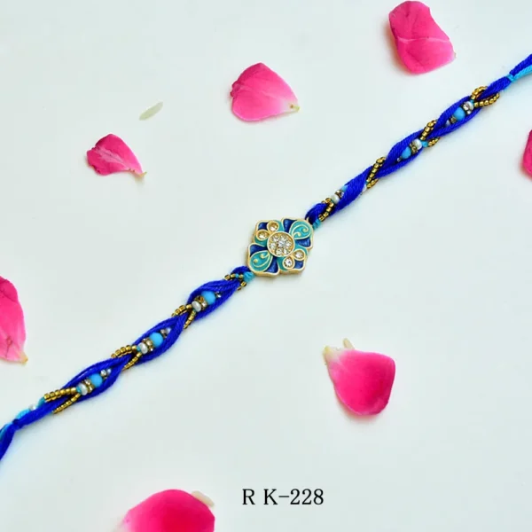 Ocean Bloom Rakhi – RK-228 | Blue Thread Rakhi with Floral Enamel & Crystal Detailing - Image 1