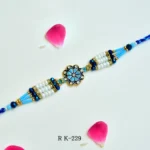 Royal Azure Pearl Rakhi – RK-229 | Floral Centerpiece with White Pearls & Blue Crystal Beads