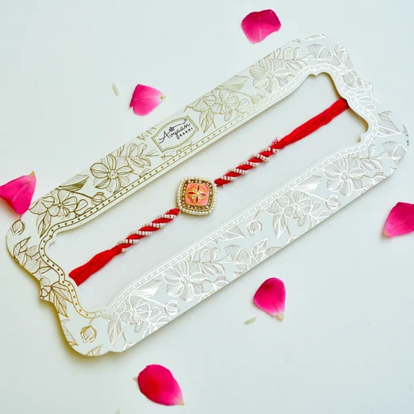 Elegant Pearl-Twist Rakhi – RK-230 | Coral Enamel Center with Golden Floral Accent - Image 2