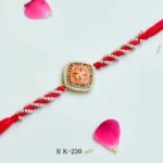 Elegant Pearl-Twist Rakhi – RK-230 | Coral Enamel Center with Golden Floral Accent