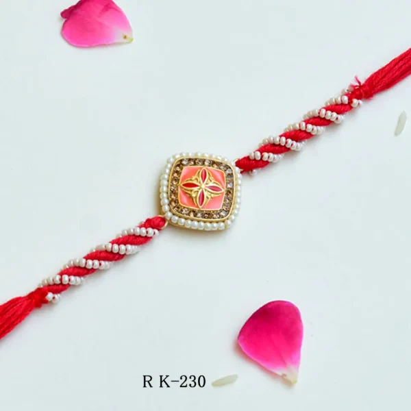 Elegant Pearl-Twist Rakhi – RK-230 | Coral Enamel Center with Golden Floral Accent - Image 1