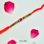 RK-250 | Traditional Wooden Beads Rakhi with Red Crystal Accent (Set of 12)