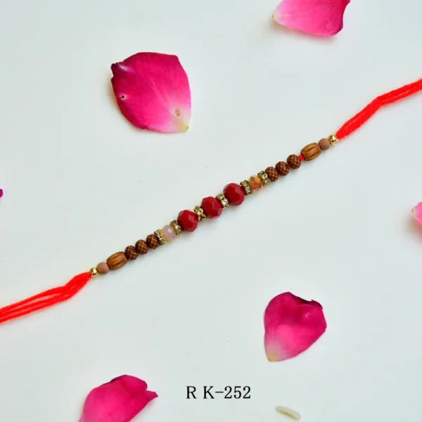 RK-252 | Traditional Rudraksha Rakhi with Red Crystal Beads & Golden Spacers (Set of 12) - Image 1