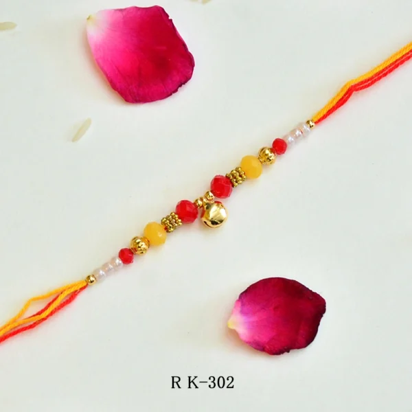 Traditional Ghungroo Rakhi | Elegant Rakhi with Red Stone, Pearl Beads & Crystal Embellishment for Brother - Image 1