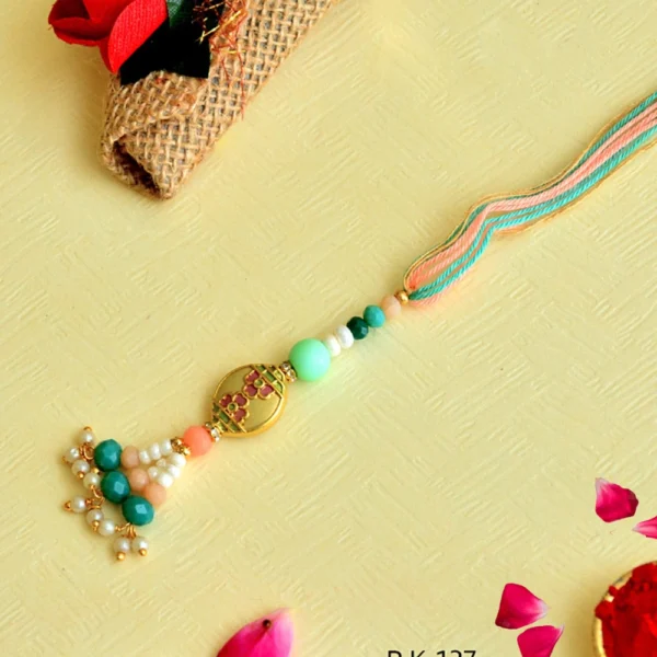 Elegant Floral Lumba Rakhi – RK-137 | Pastel Green & Peach Beads with Pearl Tassels for Bhabhi