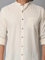 Soft cream-colored men's casual shirt with brown buttons and a chest pocket, made from eco-friendly fabrics, perfect for stylish sustainable fashion.