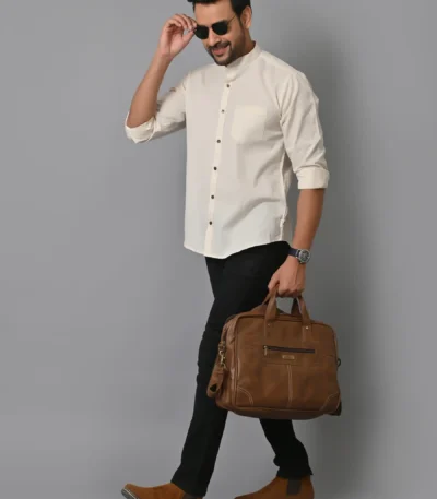Men's stylish professional attire with a white shirt, black pants, brown leather shoes, and sunglasses, carrying a brown leather briefcase, showcasing business fashion and accessories.